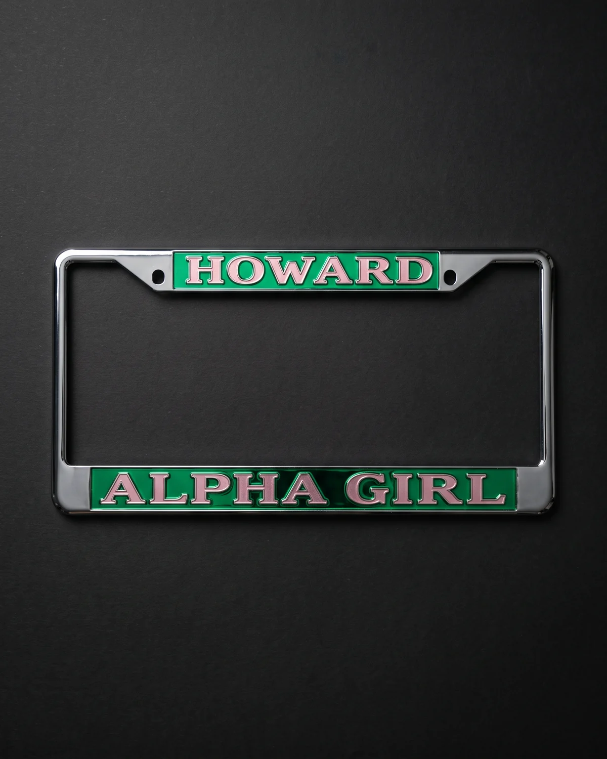 Chrome plate frame with green bars lettered in pink, Alpha Girl across the bottom